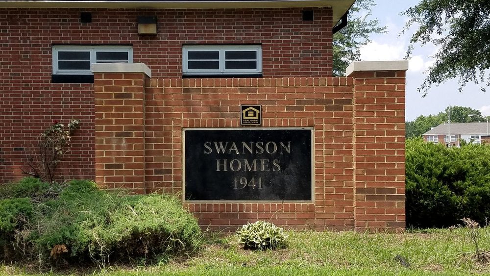 The Swanson Homes 1941 cornerstone, set in a brick wall